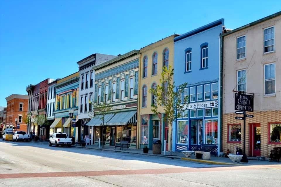 Colorful historic buildings line a sunny street.